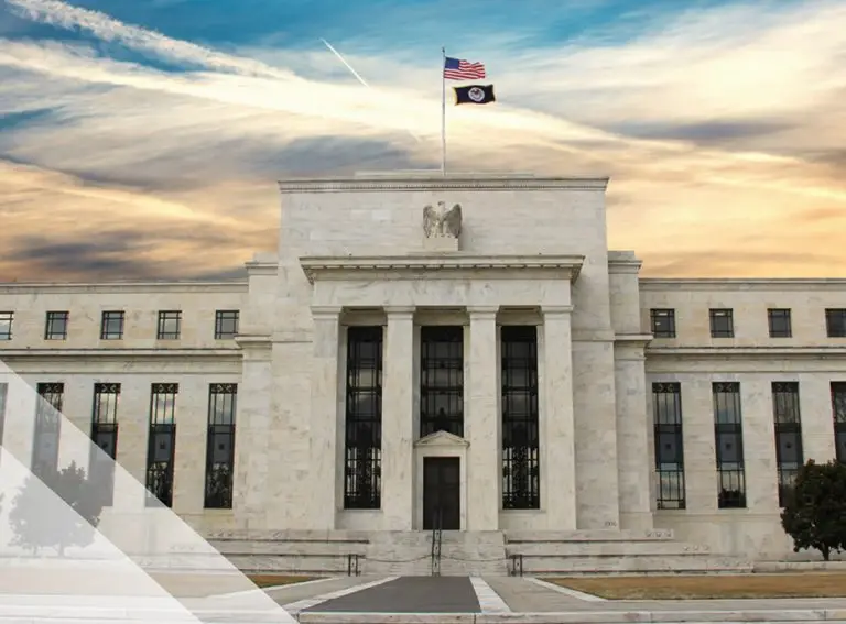 Large neoclassical government building with tall columns, an American flag and another flag on the roof, set against a dramatic sky—highlighting the importance of CMMC compliance for safeguarding national security.